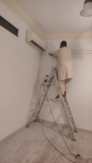 Working on a wall-mounted split AC